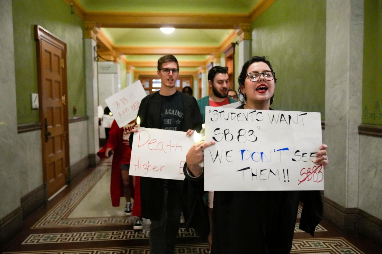 Protestors march down a hallway in the Ohio Statehouse during a protest led by the Ohio Student Association in opposition to Senate Bill 83. The bill won't pass this year.