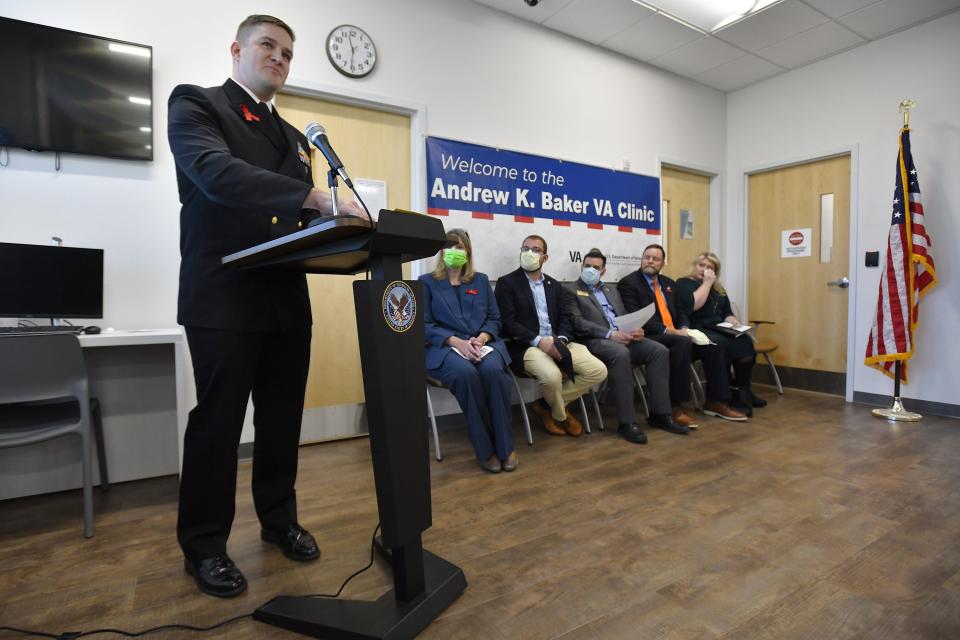 Chief Petty Officer Andrew "Drew" Baker holds back his emotions as he speaks about his father, the late Chief Petty Officer Andrew Baker, and the other men killed in a 1997 helicopter crash. Drew Baker was part of a ceremony renaming the Middleburg VA Clinic after his father.