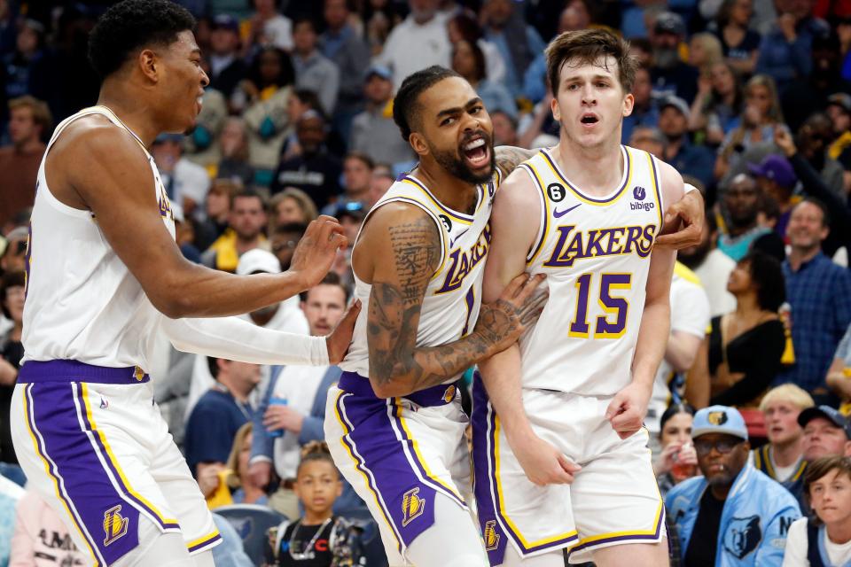 Los Angeles Lakers forward Rui Hachimura (28) and guard D'Angelo Russell (1) celebrates with guard Austin Reaves (15) during the second half of Game 1 against the Memphis Grizzlies.