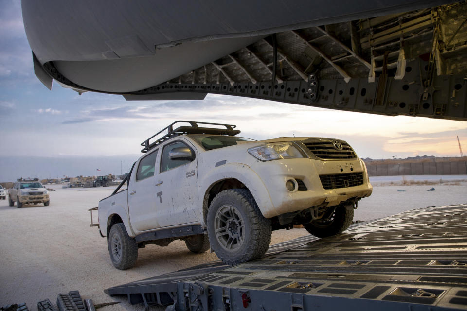 In this Oct. 25, 2019, photo, released by the U.S. Army Reserve, pickup trucks begin loading onto a cargo plane as part of the deliberate withdrawal of forces from northern Syria at the Kobani Landing Zone (KLZ), Syria. Pivoting from the dramatic killing of the Islamic State group's leader, the Pentagon is increasing U.S. efforts to protect Syria's oil fields from the extremist group as well as from Syria itself and the country's Russian allies. It's a new high-stakes mission even as American troops are withdrawn from other parts of the country.(U.S. Army Reserve photo by Staff Sgt. Joshua Hammock via AP)