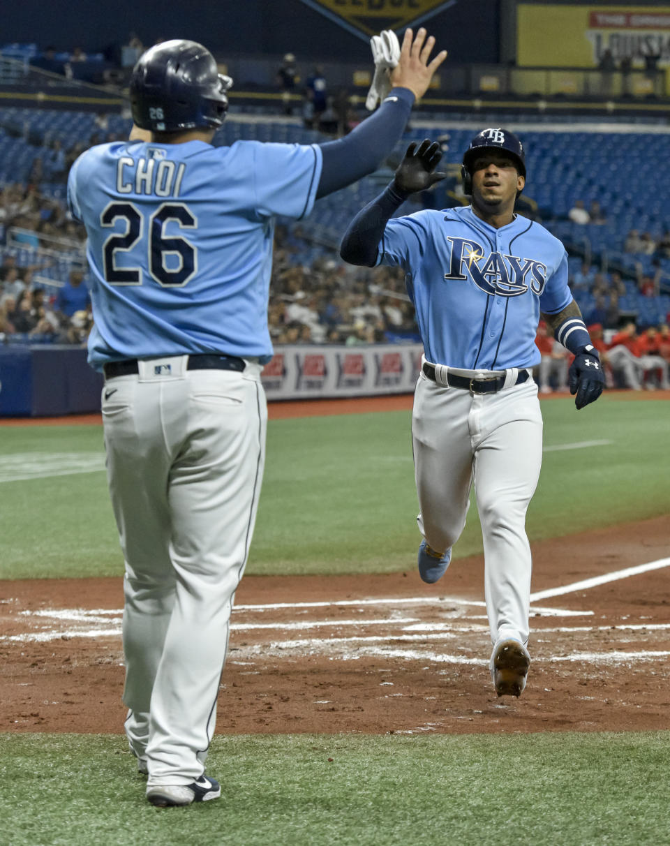 Tampa Bay Rays' Ji-Man Choi (26) and Wander Franco celebrate as they score on Austin Meadows' two-run single off Los Angeles Angels starter Griffin Canning during the first inning of a baseball game Friday, June 25, 2021, in St. Petersburg, Fla. (AP Photo/Steve Nesius)