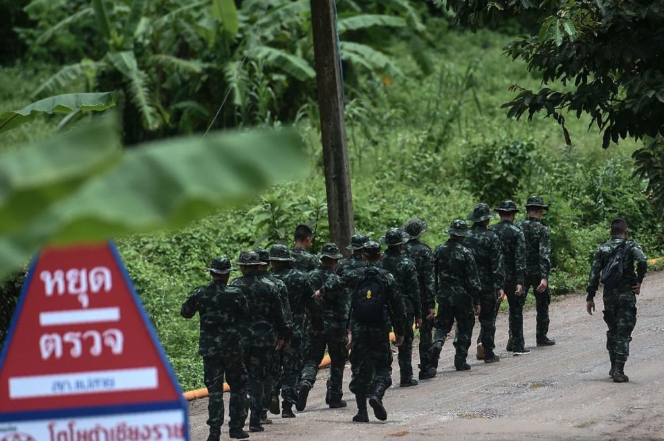 Filmmakers are facing backlash after scoping out the Thai cave site in hopes of making a film based on the 12 school boys and their soccer coach who were trapped. Pictured are Thai soldiers walking into to the Tham Luang cave area. Source: Getty