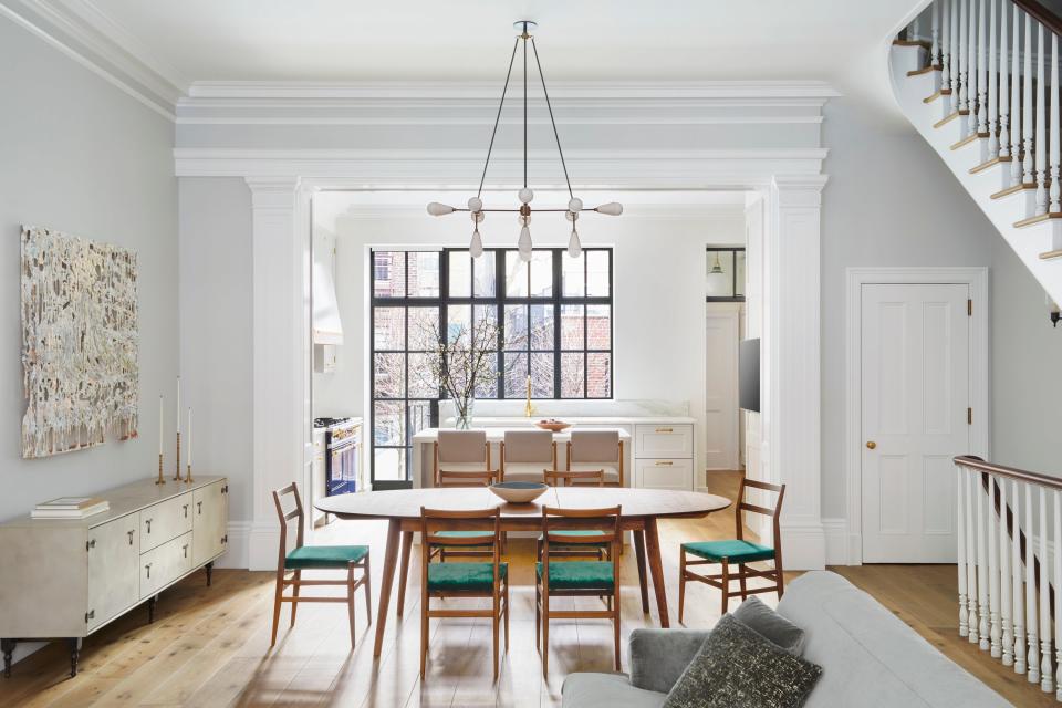 “Fitting an essentially totally open parlor floor plan together with traditionally defined rooms and all of the details that go with that was a problem that we feel we successfully solved,” says Roberts of the airy, informal design. The dining room features a custom table by Pinch Design, Cassina chairs, and an Apparatus pendant.