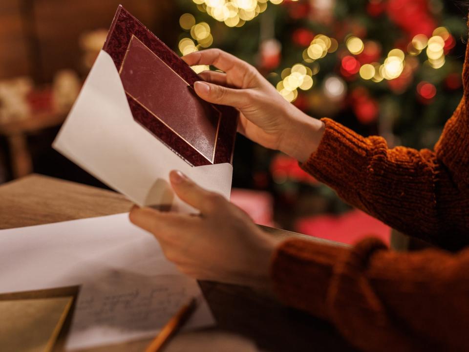 A person opens a card during the holidays.