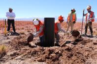 FILE PHOTO: Workers prepare to install a moisture metering system in the middle of Atacama salt flat