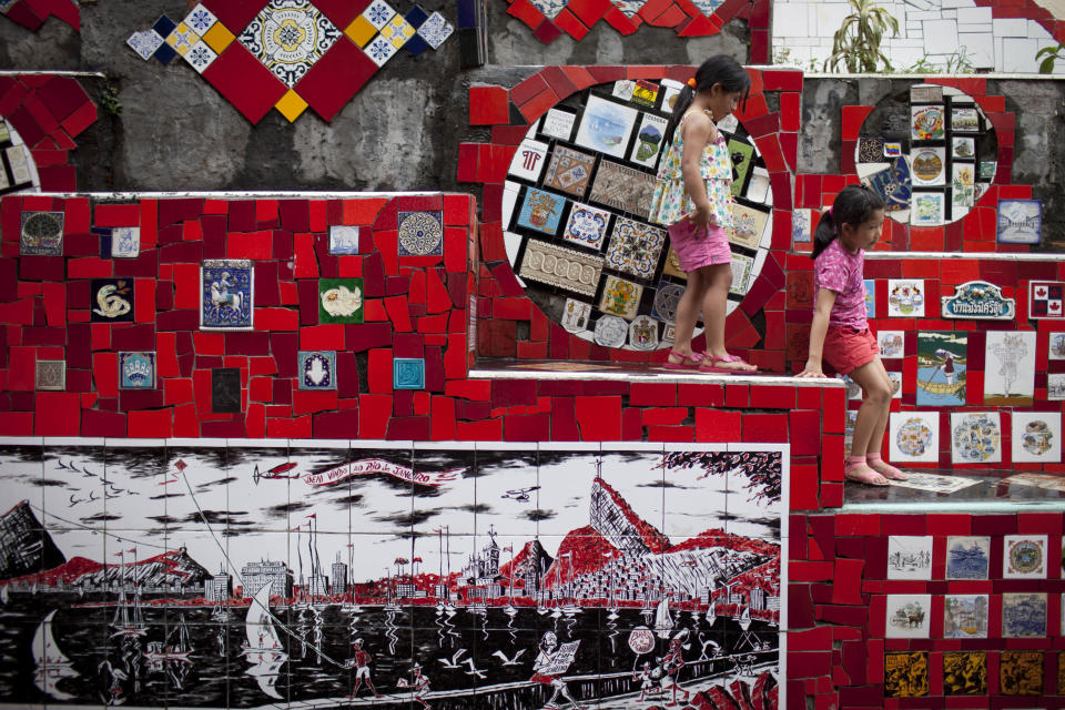 Young visitors from Colombia play on a stairway that was decorated by Chilean artist Jorge Selaron, which he titled the "Selaron Stairway" in Rio de Janeiro, Brazil, Thursday, Jan. 10, 2013. Selaron, an eccentric Chilean artist and longtime Rio resident who created a massive, colorful tile stairway in the bohemian Lapa district that's popular with tourists, was found dead on the stairway on Thursday. He was 54. Authorities are investigating the cause of death. (AP Photo/Felipe Dana)