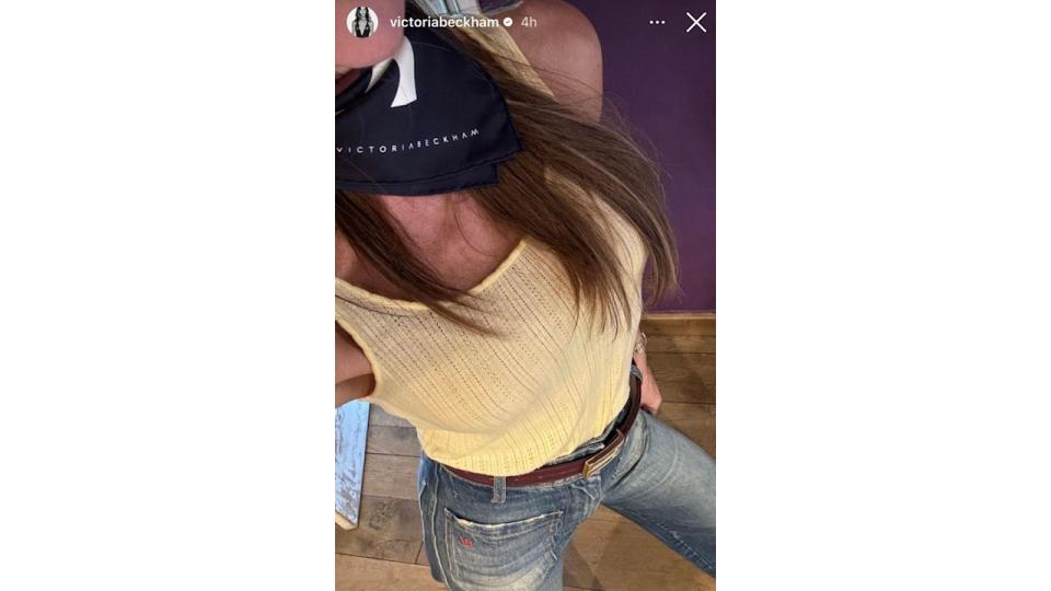 Victoria Beckham wearing her new denim jeans and a yellow vest top