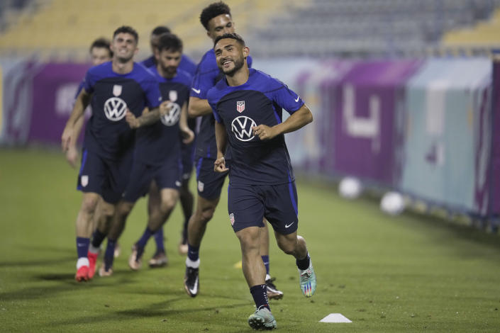 United States midfielder Cristian Roldan, center, and other players participate in an official training session at Al-Gharafa SC Stadium, in Doha, Saturday, Nov. 19, 2022. (AP Photo/Ashley Landis)