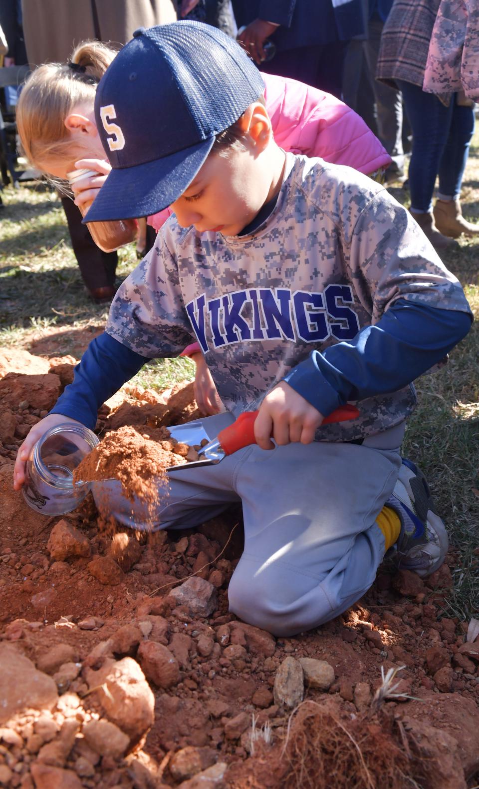A groundbreaking ceremony was held for the baseball stadium in downtown Spartanburg on Nov. 1, 2023. Bennett Boles of the 6 and under Hillbrook Vikings baseball collects his soil as a souvenir at the groundbreaking.