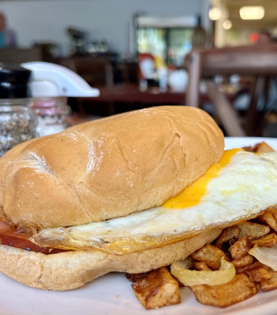 The breakfast sandwich at The Lighthouse Cafe comes with two eggs, melted cheddar cheese, and ham, bacon or sausage on a grilled Kaiser roll.