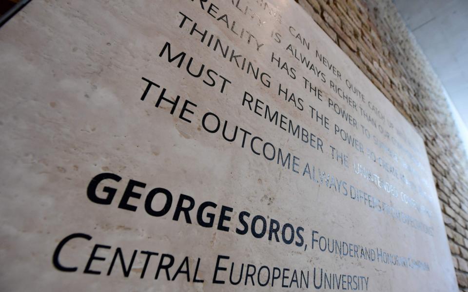 A quote of the founder of the English-language Central European University (CEU) Hungarian born American businessman George Soros is seen at the main entrance in Budapest  - Credit: AFP