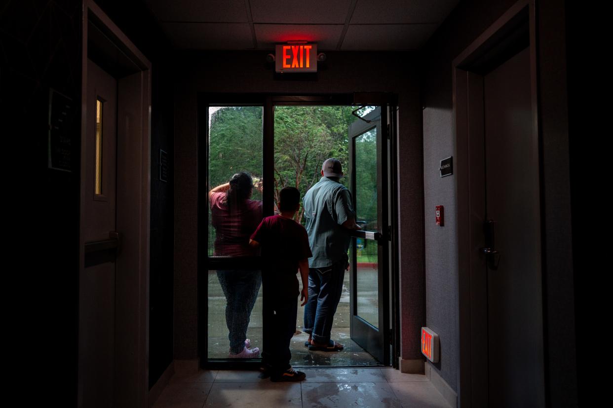 A family watches Hurricane Francine from their hotel on September 11, 2024 in Houma, Louisiana. Francine has been upgraded to a Category 2 hurricane and continues to make landfall along the Louisiana coast. Weather analysts are predicting 90mph winds near the eye and a strong storm surge along the coast.