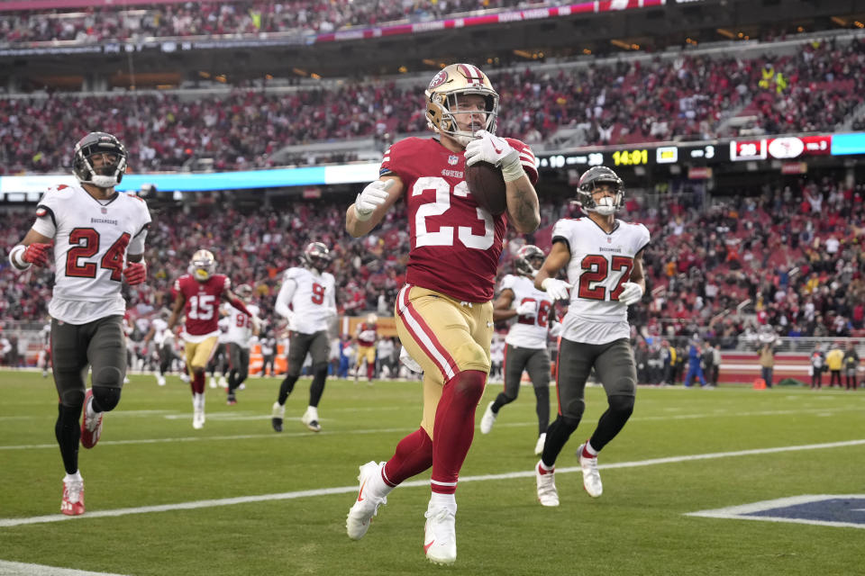 San Francisco 49ers running back Christian McCaffrey (23) runs for a touchdown during the second half of an NFL football game against the Tampa Bay Buccaneers in Santa Clara, Calif., Sunday, Dec. 11, 2022. (AP Photo/Tony Avelar)