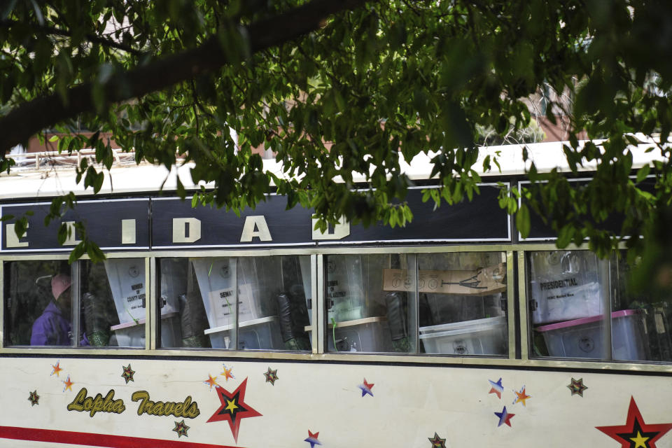 A worker drives in a minibus transporting ballot boxes to a collection and tallying center in Nairobi, Kenya Wednesday, Aug. 10, 2022. Kenyans are waiting for the results of a close but calm presidential election in which the turnout was lower than usual. (AP Photo/Mosa'ab Elshamy)