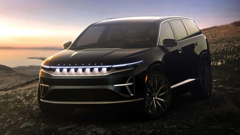 a black car parked on a dirt road with a sunset in the background