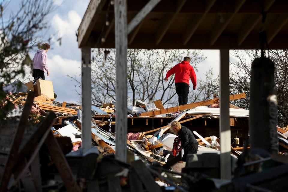Families sift through the damage from a tornado along Arabian Road in Omaha, Neb., Friday, April 26, 2024. (Nikos Frazier/Omaha World-Herald via AP)