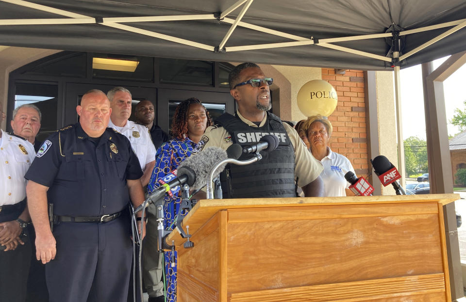 Henry County Sheriff Reginald Scandrett speaks on Sunday, July 16, 2022, in Hampton, Ga, while flanked by other police and local officials. Scandrett announced that officers shot and killed Andre Longmore on Sunday, a day after officials say Longmore shot and killed four Hampton residents (AP Photo/Jeff Amy)