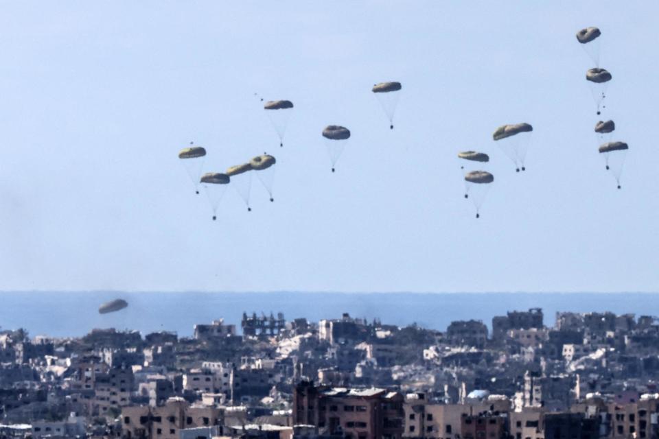PHOTO: Humanitarian aid is airdropped by a military transport aircraft above the northern Gaza Strip, as seen from the Israeli side in southern Israel, Mar. 10, 2024.<p>(Menahem Kahana/AFP via Getty Images)