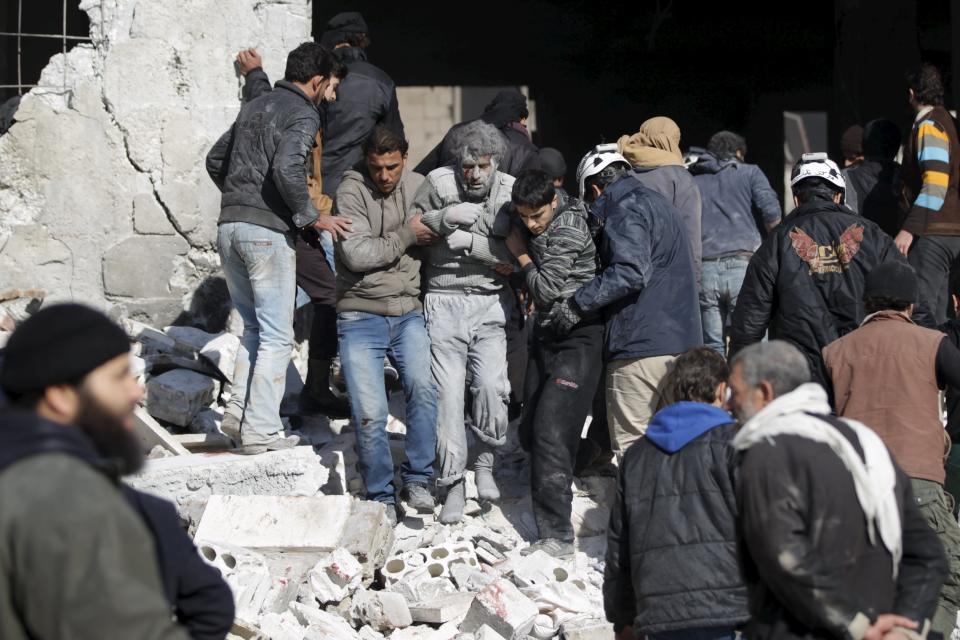 ATTENTION EDITORS - VISUAL COVERAGE OF SCENES OF DEATH AND INJURYResidents help an injured man in a site hit by what activists said were airstrikes carried out by the Russian air force in the rebel-controlled area of Maaret al-Numan town in Idlib province, Syria January 9, 2016. At least 70 people died in what activists said where 4 vacuum bombs dropped by the Russian air force in the town of Maaret al-Numan; other air strikes were also carried out in the towns of Saraqib, Khan Sheikhoun and Maar Dabseh, in Idlib. REUTERS/Khalil Ashawi