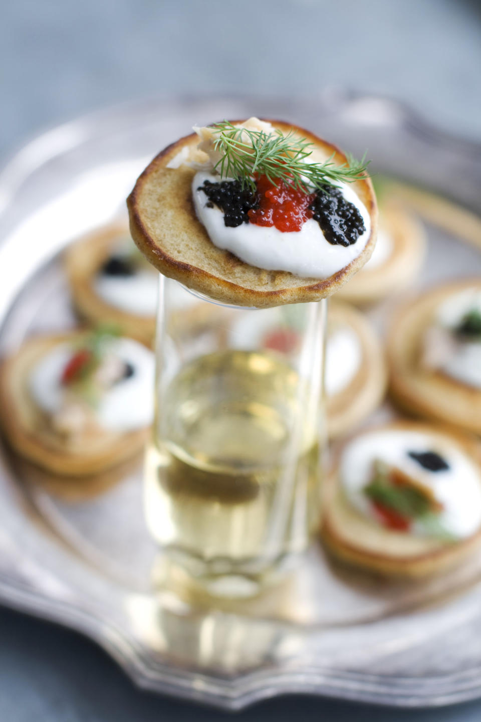 This Jan. 28, 2013 photo shows blini with smoked trout, caviar and horseradish cream served on a platter in Concord, N.H. These elegant hors d'oeuvres are perfect for an Oscar night viewing party. (AP Photo/Matthew Mead)