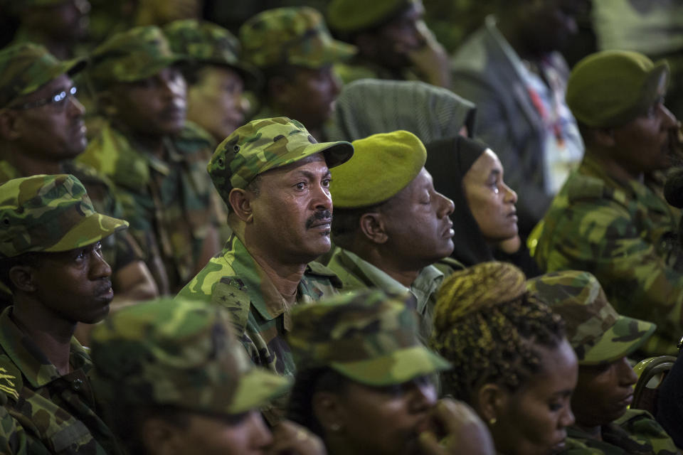 Members of the military shed a tear during a state ceremony for assassinated army chief Gen. Seare Mekonnen, at the Millennium Hall in the capital Addis Ababa, Ethiopia Tuesday, June 25, 2019. Ethiopia's Prime Minister Abiy Ahmed sobbed openly at the service Tuesday for the military chief who was assassinated by his own bodyguard over the weekend. (AP Photo/Mulugeta Ayene)