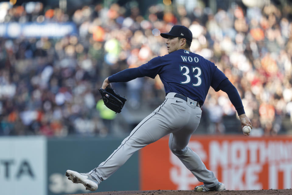 Seattle Mariners starting pitcher Bryan Woo throws in the first inning of a baseball game against the San Francisco Giants in San Francisco, Monday, July 3, 2023. (AP Photo/Josie Lepe)