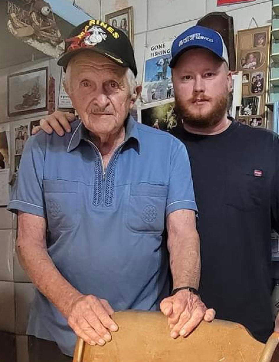 Joe Barna, who, as a Marine in the Korean War carried a flamethrower, stands with Ryan Walkowski, a Wittenberg writer who travels the country to collect stories from Korean War veterans.