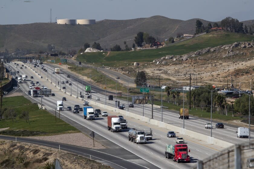 JARUPA VALLEY, CALIF. -- WEDNESDAY, FEBRUARY 12, 2020: Traffic flows on the 60 Freeway as the Center for Community Action and Environmental Justice counts diesel trucks passing by in Jarupa Valley, Calif., on Feb. 12, 2020. The truck-counting activity was to count the rising number of diesel trucks passing through the Inland Empire. The group says that reality underscores the need for state regulators to pass tough rules requiring trucks to shift to electricity and other zero-emissions technology. (Allen J. Schaben / Los Angeles Times)