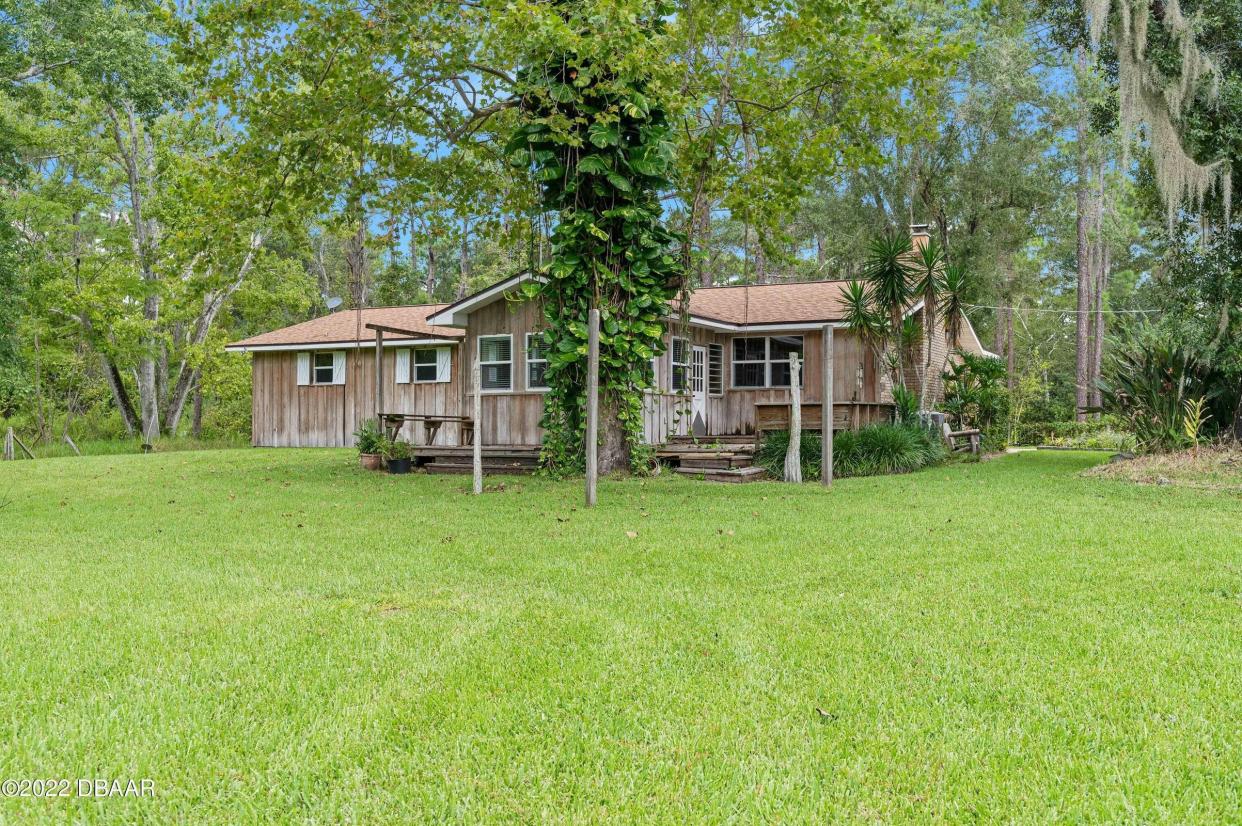 This beautiful solid concrete-block home is adorned with a brick front and beautiful cypress siding along the sides and rear.