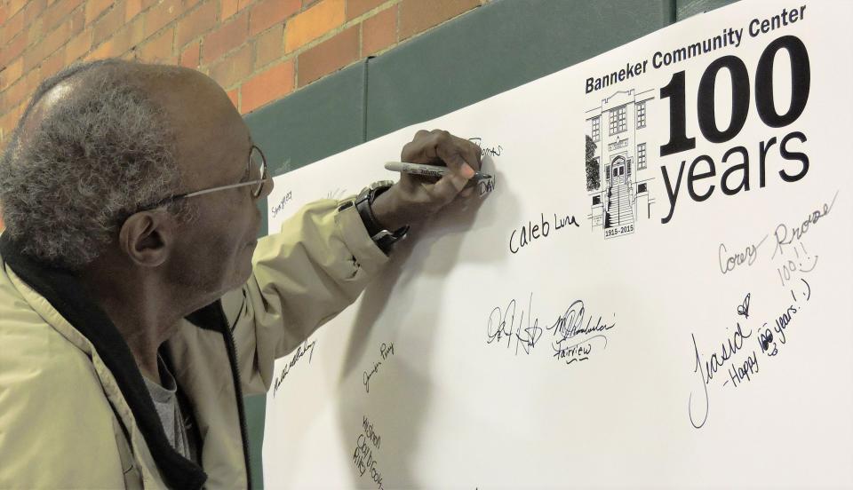 David P. Bridgwaters signs the "guest book" Wednesday at the 100-year celebration at Banneker Community Center in 2015.