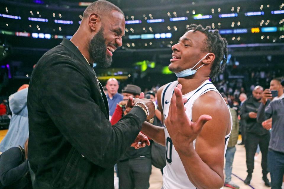 LOS ANGELES, CA - DECEMBER 04: Lebron James comes onto the court to congratulate his son Bronny James (0) point guard for Sierra Canyon after his team won against St. Vincent-St. Mary during The Chosen - 1's Invitational High School Basketball Showcase at the Staples Center on Saturday, Dec. 4, 2021 in Los Angeles, CA. (Jason Armond / Los Angeles Times via Getty Images)