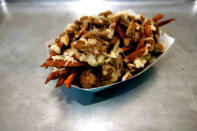 Crispy sweet potato fries, braised chicken, white cheddar and cashews are served at Frysmith in Los Angeles.