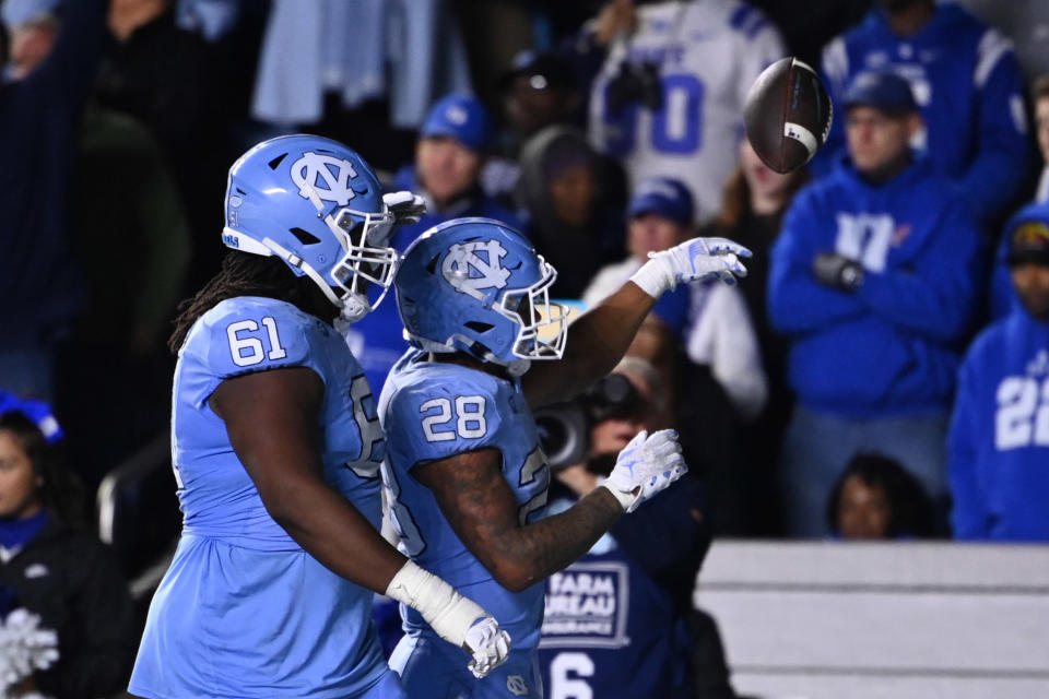 Nov 11, 2023; Chapel Hill, North Carolina, USA; North Carolina Tar Heels running back Omarion Hampton (28) with offensive lineman Diego Pounds (61) after scoring a touchdown in the fourth quarter at Kenan Memorial Stadium. Mandatory Credit: Bob Donnan-USA TODAY Sports