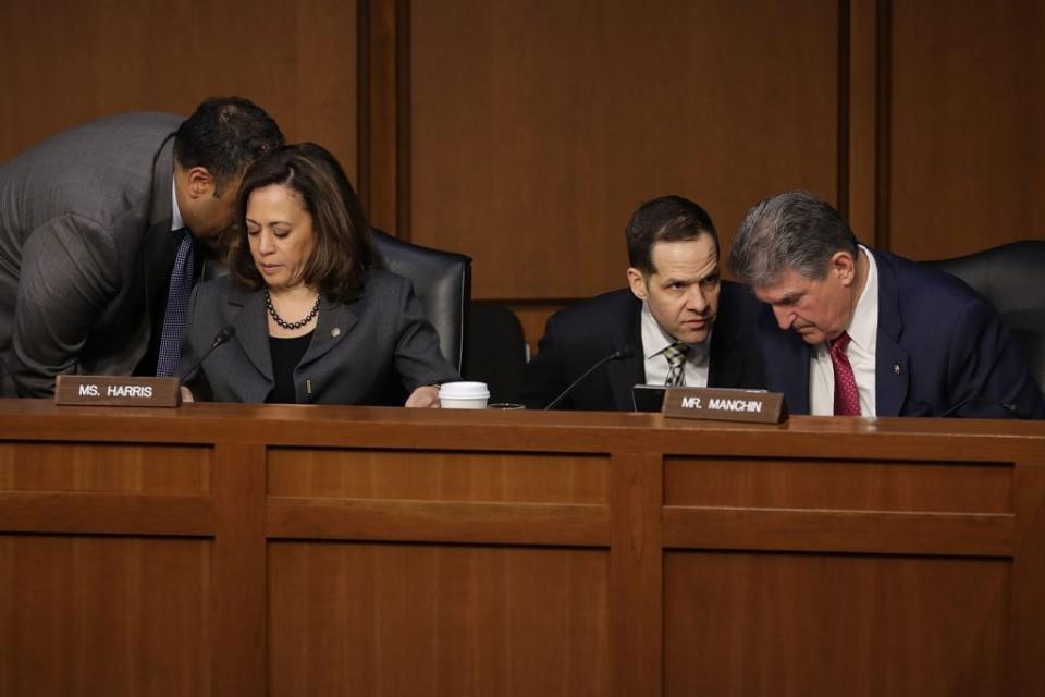 Senate Intelligence Committee members Sen. Kamala Harris (D-CA) and Sen. Joe Manchin (D-WV) hear from staff members during a committee hearing in the Hart Senate Office Building on Capitol Hill March 21, 2018 in Washington, DC. (Photo by Chip Somodevilla/Getty Images)