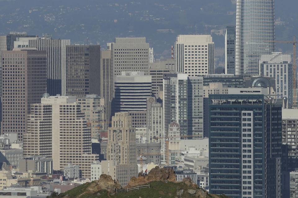 A man climbs a bluff on Corona Heights in front of the skyline seen from Tank Hill in San Francisco, Wednesday, Feb. 26, 2020. California officials are bracing for the potential of another drought and an early and more intense wildfire season amid a record-breaking warm and dry February. (AP Photo/Jeff Chiu)