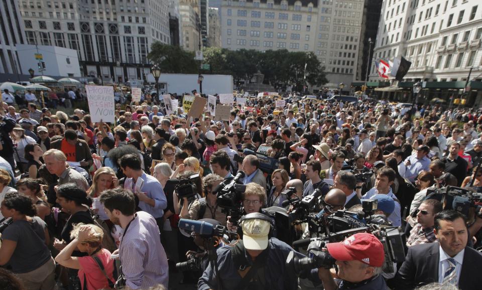 Members of the Occupy Wall St movement protest on 5th Avenue while marching through the upper east side of New York