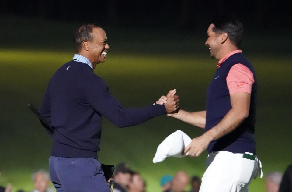 Tiger Woods of the United States, left, and Jason Day of Australia, right, hold their hands on the 18th hole after the Challenge: Japan Skins event ahead of the Zozo Championship PGA Tour at Accordia Golf Narashino C.C. in Inzai, east of Tokyo, Monday, Oct. 21, 2019. (AP Photo/Lee Jin-man)