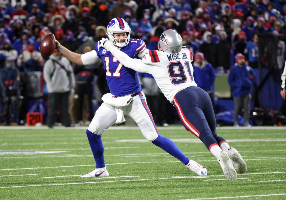 Buffalo Bills quarterback Josh Allen fights off a sack by New England Patriots Deatrich Wise Jr. during a Dec. 26 game.