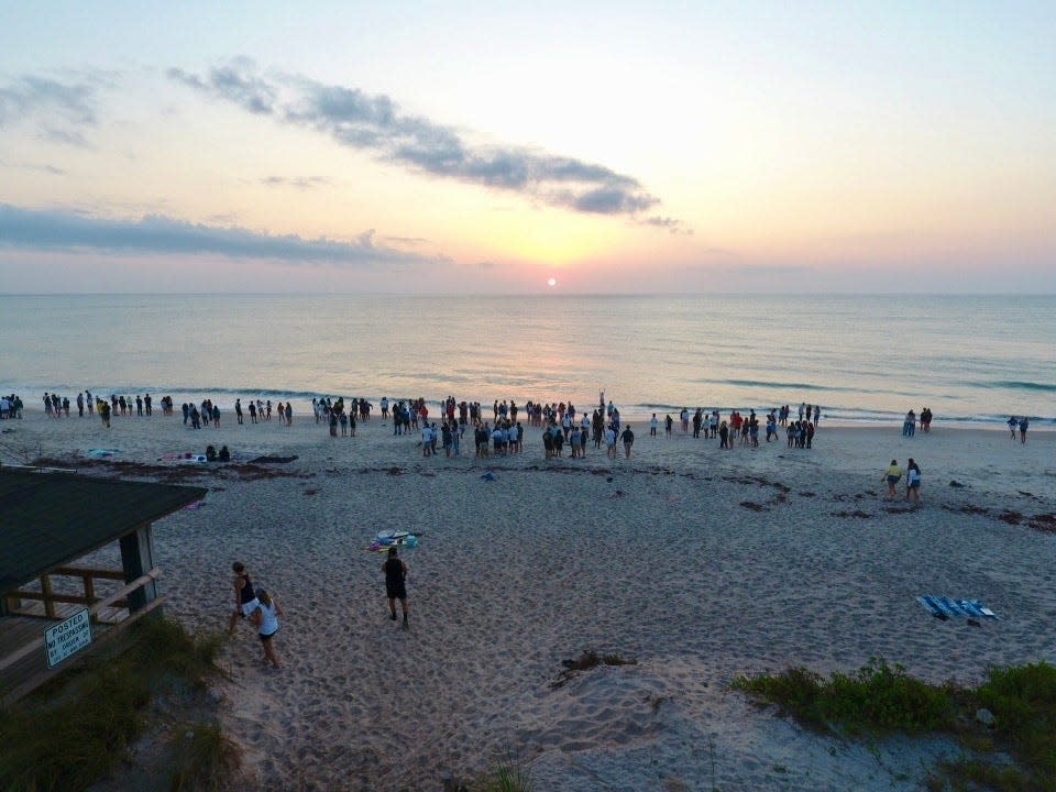 In this drone image, Vero Beach High School seniors watch the sunrise, Friday, May 10, 2024, at Humiston Beach Park before their last day of school. Graduation is Friday, May 17 at 7 p.m. at the Citrus Bowl.