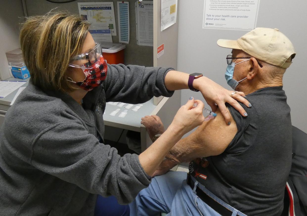 Erin Barnett, public health nurse, administers a COVID-19 vaccination to Howard Stineman of Bucyrus during a clinic in January 2021.