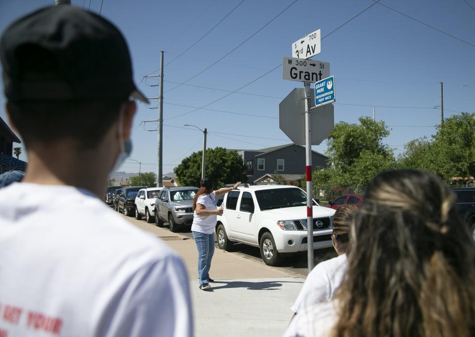 Volunteers canvas to encourage getting the COVID-19 vaccine in the neighborhood surrounding Grant Park in Phoenix on May 22, 2021.