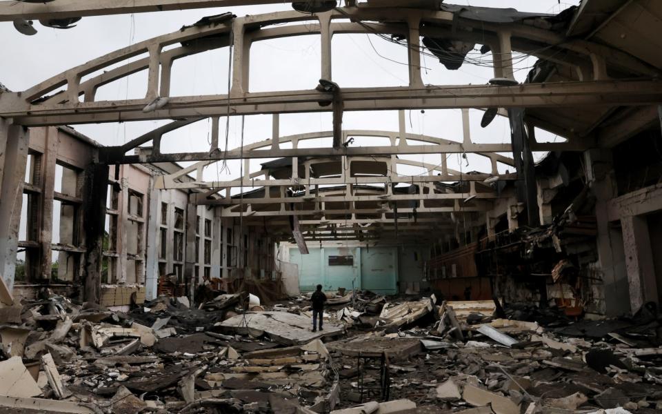 People survey the damage after a sports complex of an educational institution was shelled overnight as Russiaâ€™s attack on Ukraine continues in Kharkiv, Ukraine June 24, 2022. - REUTERS/Leah Millis