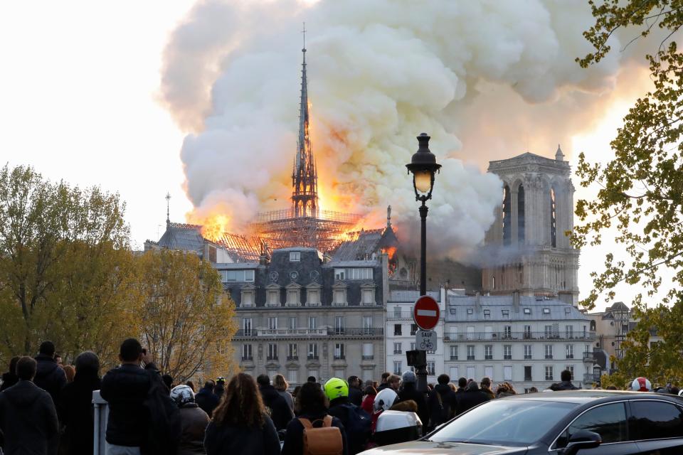 Seen from across the Seine River, smoke and flames rise during a fire at the landmark Notre-Dame Cathedral in central Paris on April 15, 2019, potentially involving renovation works being carried out at the site, the fire service said. (Photo by FRANCOIS GUILLOT / AFP)        (Photo credit should read FRANCOIS GUILLOT/AFP/Getty Images)