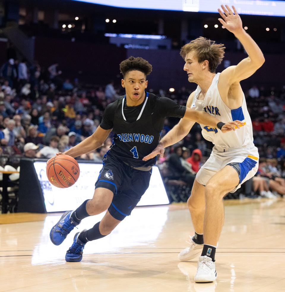 Greenwood’s Tanner Jones drives around Bolivar’s Lukas Gabani during the semifinal round of the gold division at the Blue and Gold Tournament on December 29, 2021.