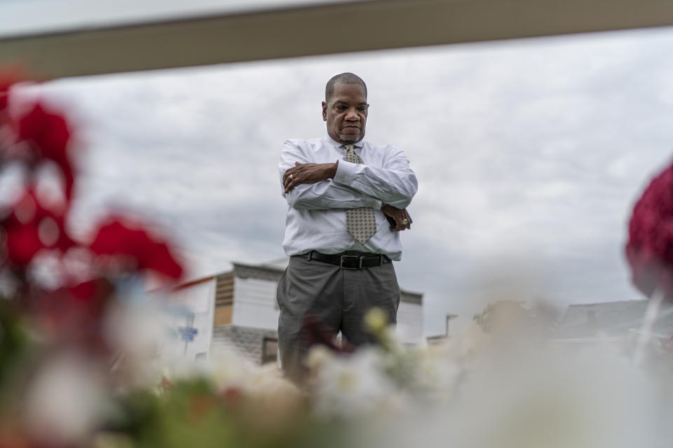On Sunday, Aug. 20, 2023, the Rev. Jimmie Hardaway Jr. stands at a memorial to the 10 people killed when a shooter targeted Black shoppers at a Tops supermarket in 2022, in Buffalo, N.Y. Hardaway knows the place well. He grew up a few blocks away, works as a substitute teacher at a nearby school and shops at the store from time to time. The morning after the shooting, he drove to the scene, offering to pray with those grieving. (AP Photo/David Goldman)