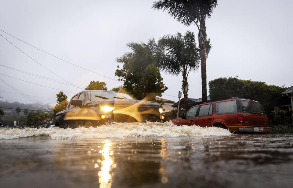 A truck drives through a flooded street during a rainstorm, Sunday, Feb. 4, 2024, in Santa Barbara, Calif. / Credit: Ethan Swope / AP