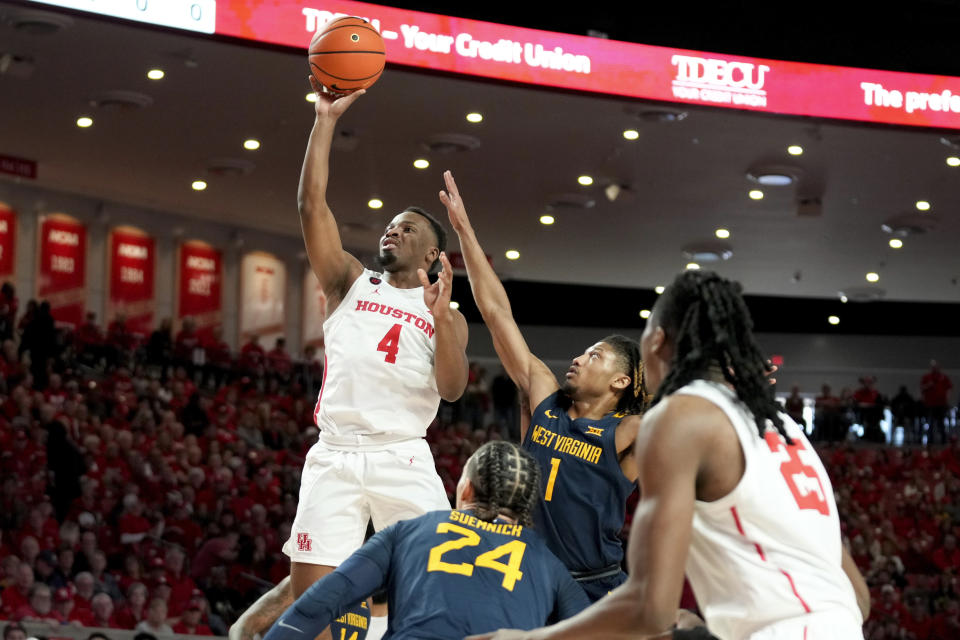 Houston guard L.J. Cryer (4) shoots as West Virginia guard Noah Farrakhan (1) defends during the first half of an NCAA college basketball game Saturday Jan. 6, 2024, in Houston. (AP Photo/Eric Christian Smith)