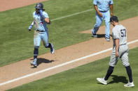 Toronto Blue Jays' Bo Bichette, left, comes in to score on his game-winning home run off of New York Yankees relief pitcher Chad Green (57) during the ninth inning of a baseball game Wednesday, April 14, 2021, in Dunedin, Fla. The Blue Jays won 5-4. (AP Photo/Mike Carlson)