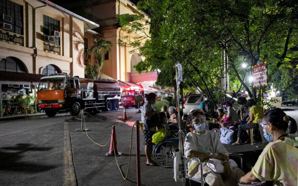 Patients of Philippine General Hospital are evacuated after a fire broke out at the facility - Eloisa Lopez/Reuters