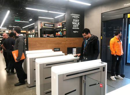 A shopper scans a smartphone app associated with his Amazon account and credit card information to enter the Amazon Go store in Seattle, Washington, U.S., January 18, 2018. Photo taken January 18, 2018. REUTERS/Jeffrey Dastin